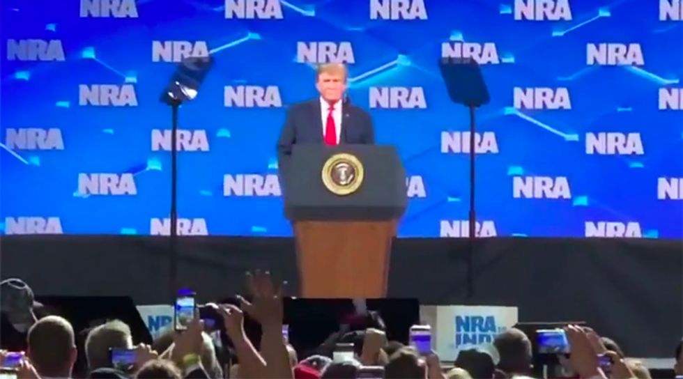 WATCH: NRA convention attendee throws phone at Trump as he walks on stage