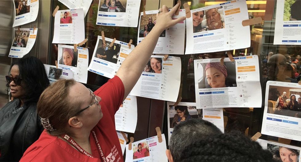 Demanding Medicare for All -- nurses use Band-Aids to plaster GoFundMe pages to big pharma headquarters