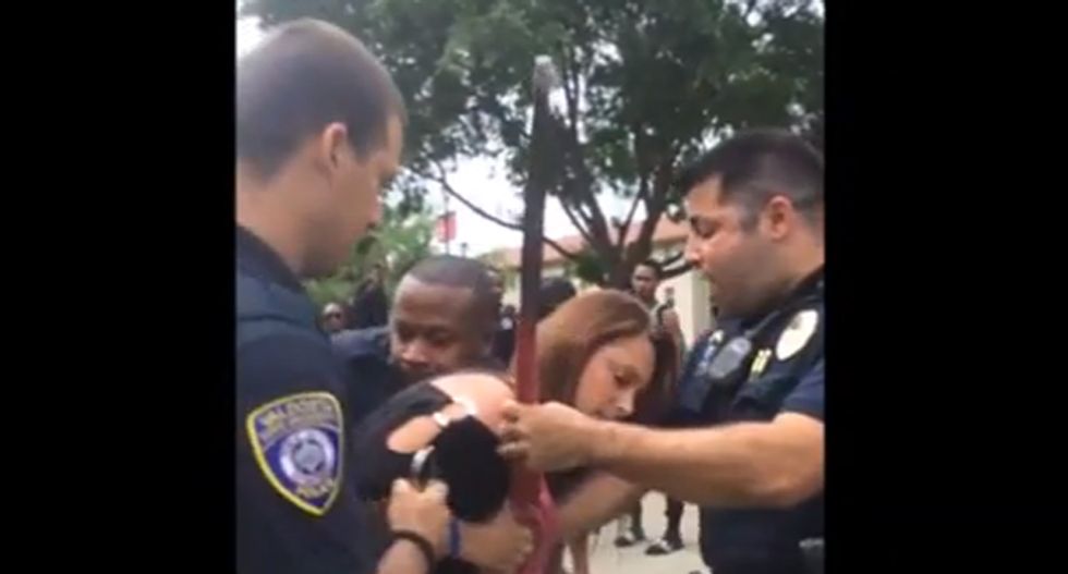 WATCH: Woman fights with police after stealing American flag from protesters who were 'desecrating' it