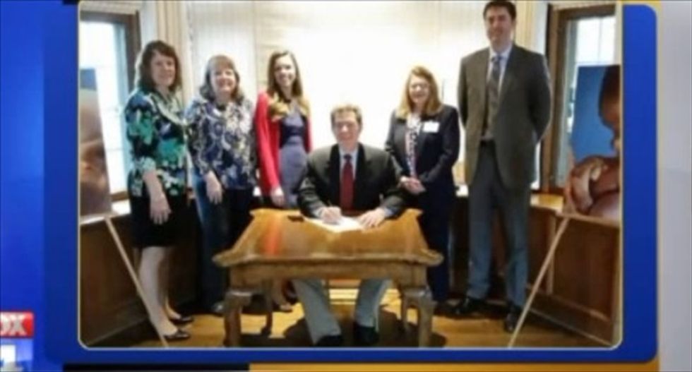 Kansas Gov. Brownback stages weird 're-enactments' of himself signing anti-abortion bill