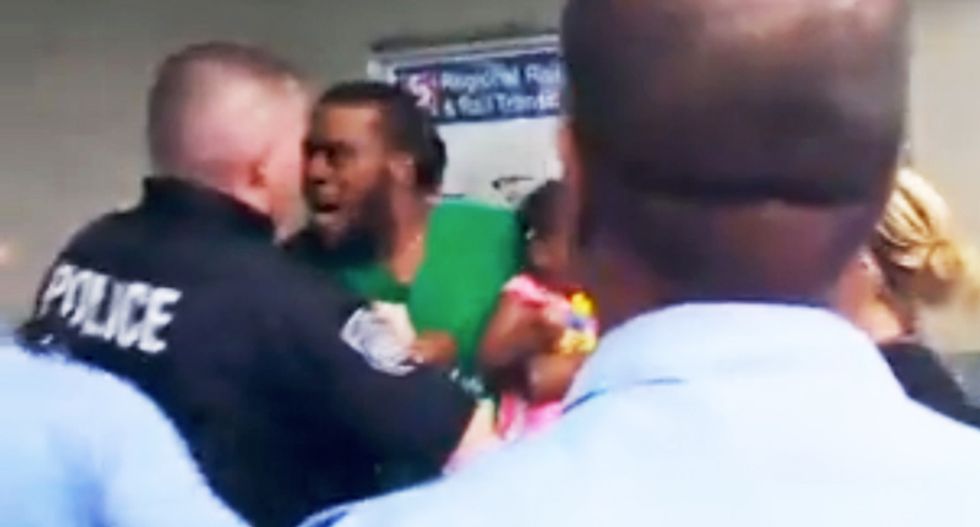 WATCH: Mob of Philly cops assault man holding crying baby for not paying his $2.25 transit fare