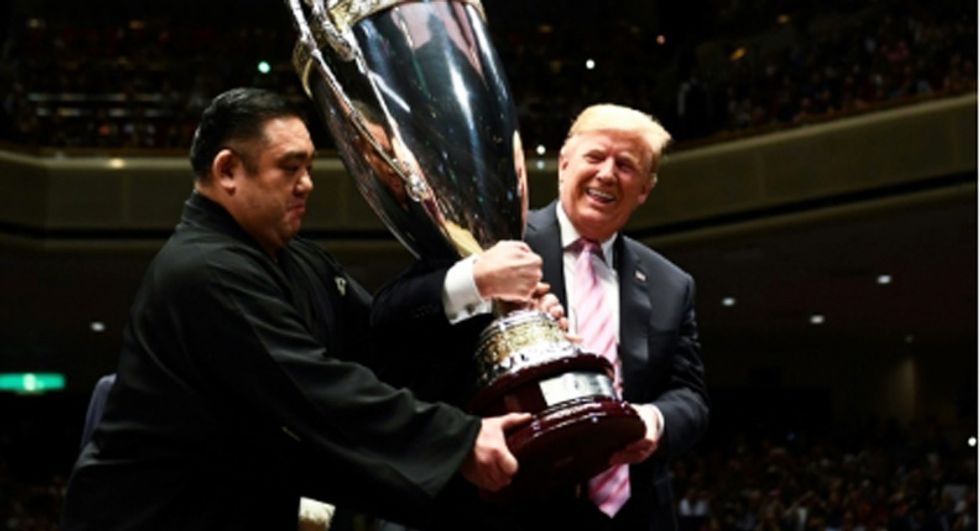 Trump gets 'scattered boos' as he joins Japan PM Abe at sumo match: report
