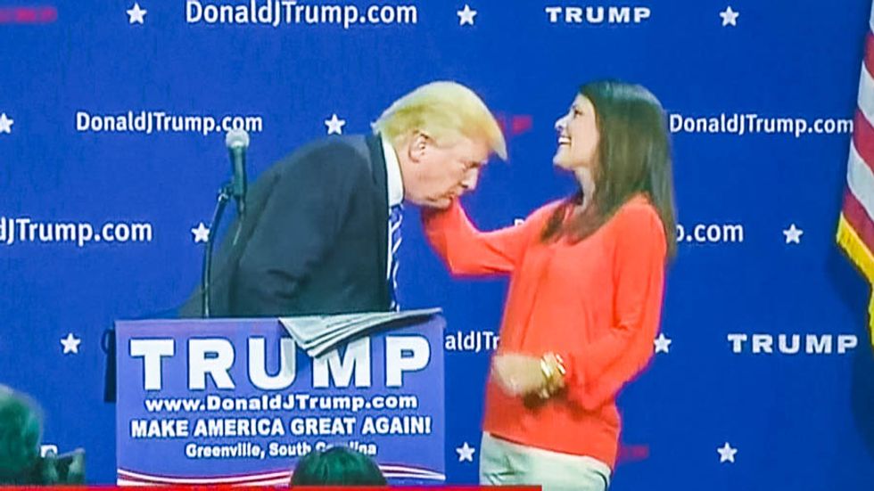 'Somebody's got a very nice wife': Donald Trump forces random woman to come onstage to feel his hair