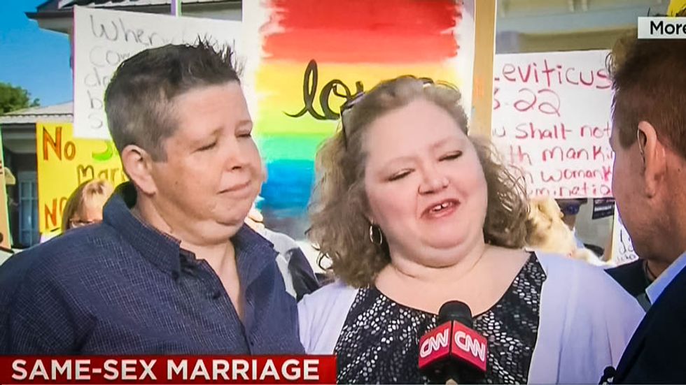 WATCH: Kim Davis' clerk issues marriage license to lesbians while Christians shout they are going to Hell