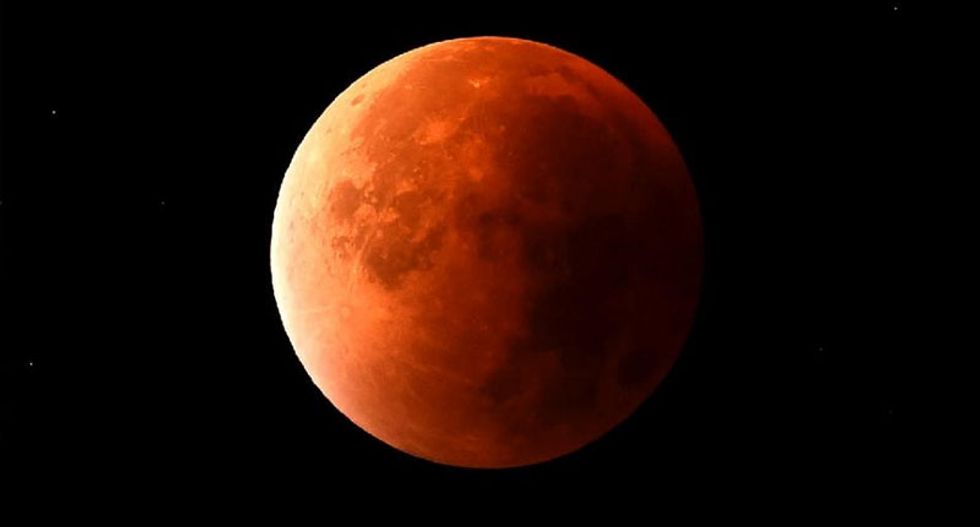 Skygazers treated to rare combined 'super blood moon' and eclipse