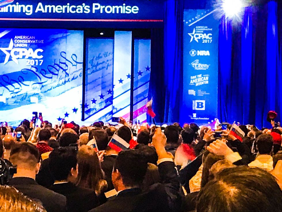 CPAC scrambles to control damage after attendees wave Russian flags during Trump speech