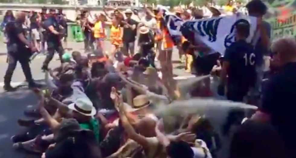 WATCH: On 'hottest day in history of France,' police tear-gas climate campaigners in Paris