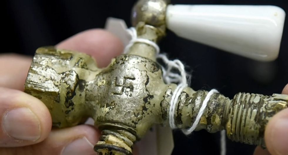 'It's capitalism at its worst': Nazi gas chamber valve and slave collar among items hawked at Florida auction