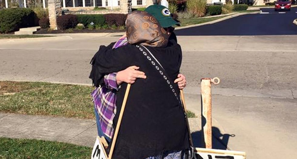 Lonely anti-Muslim protester greeted lovingly with hugs and invitation to learn about Islam -- and she does