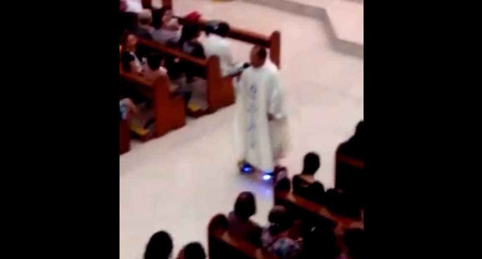 Catholic priest in trouble after he's filmed riding a hoverboard during Christmas Eve Mass