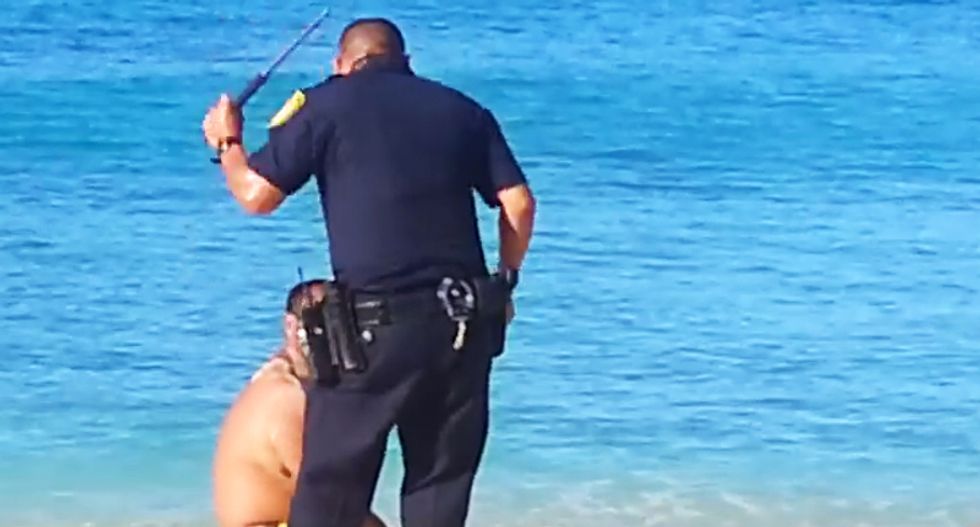 Cop savagely beats Hawaiian man after he performs native 'healing prayer' near seal on the beach