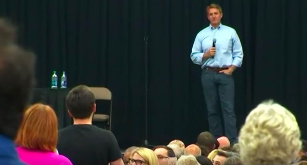 'Can you please take your job more seriously?': GOP Sen. Flake shouted down at town hall for defending Trump