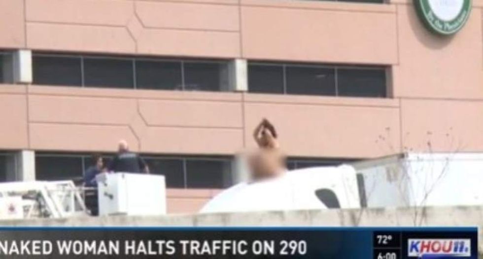 Naked woman snarls traffic on Houston highway after climbing atop truck