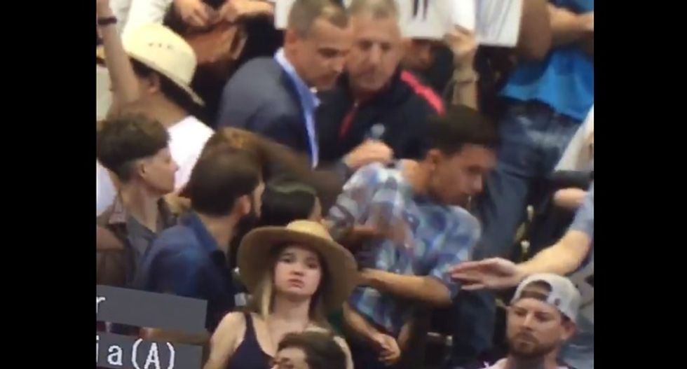 While video appears to show otherwise, Trump campaign denies manager yanked protester by the collar