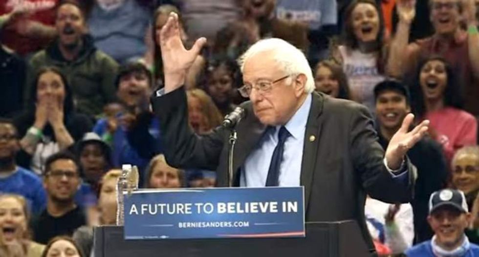 Crowd explodes into cheers after bird flies onto Bernie Sanders' podium during rally