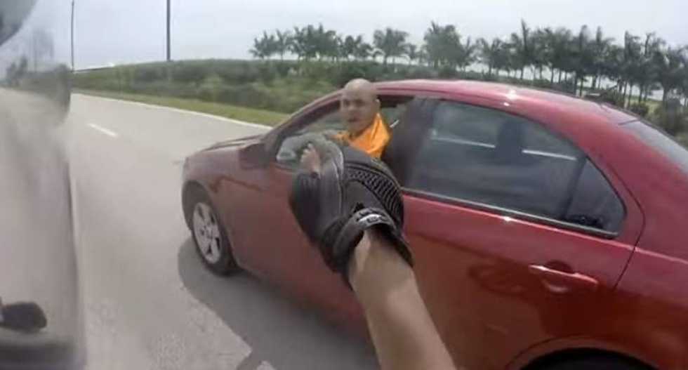 WATCH: Shouting road raging motorist tries to drive biker off the road