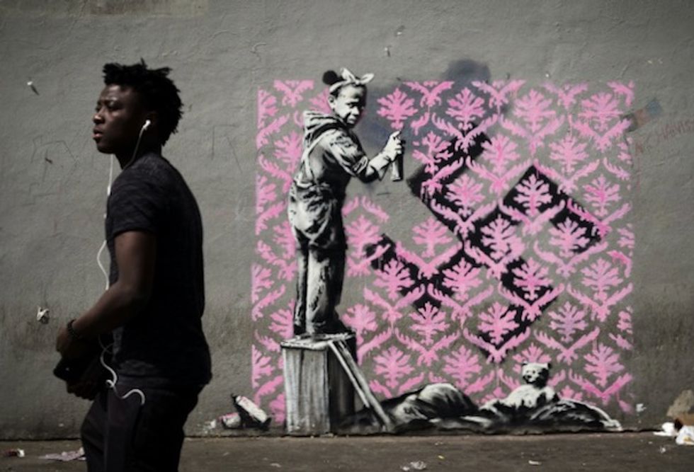 Banksy needles France on migrants with Paris mural blitz