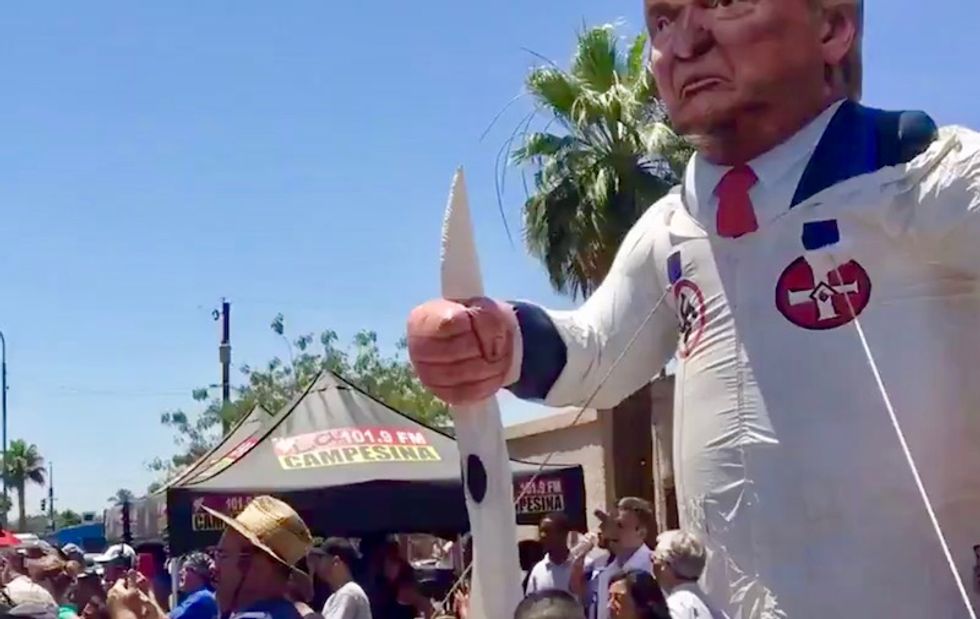WATCH: Arizona protestors chase after Melania's motorcade after she is greeted at detention center with Trump klansman statue