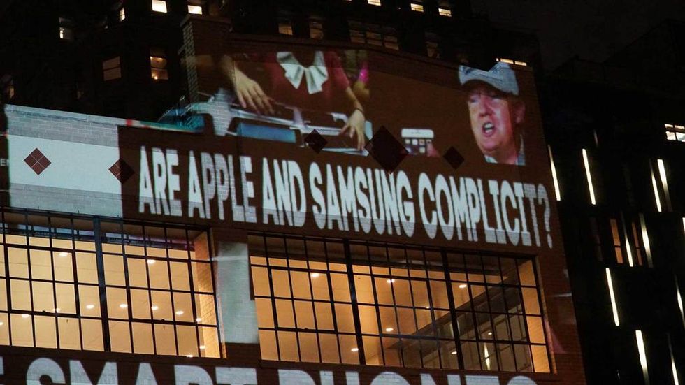 'Pay Trump bribes here' artist strikes again to call out 'complicit' Apple for poor working conditions overseas