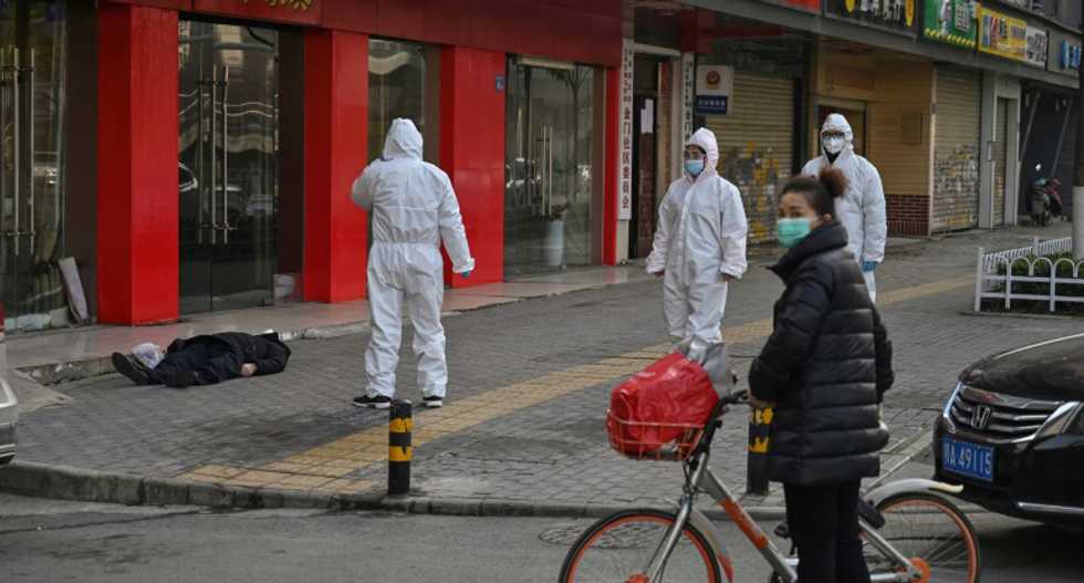 Dead man lies on an empty street at China's virus ground zero