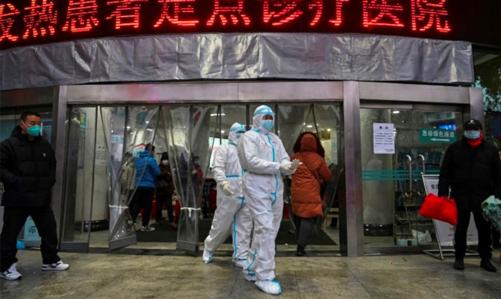 New Chinese city locked down over virus, first foreign death reported