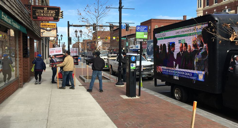 Pro-Trump truck flashes high-wattage TV clips about Hunter Biden outside New Hampshire climate town hall