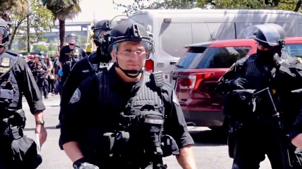 Video shows Portland cops charging peaceful protestors after realizing they'd forgotten two police cars behind protest line