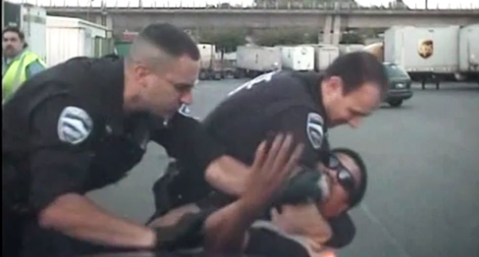 WATCH: Cops hold man down and sic K-9 on him after beating him -- for dancing in a parking lot
