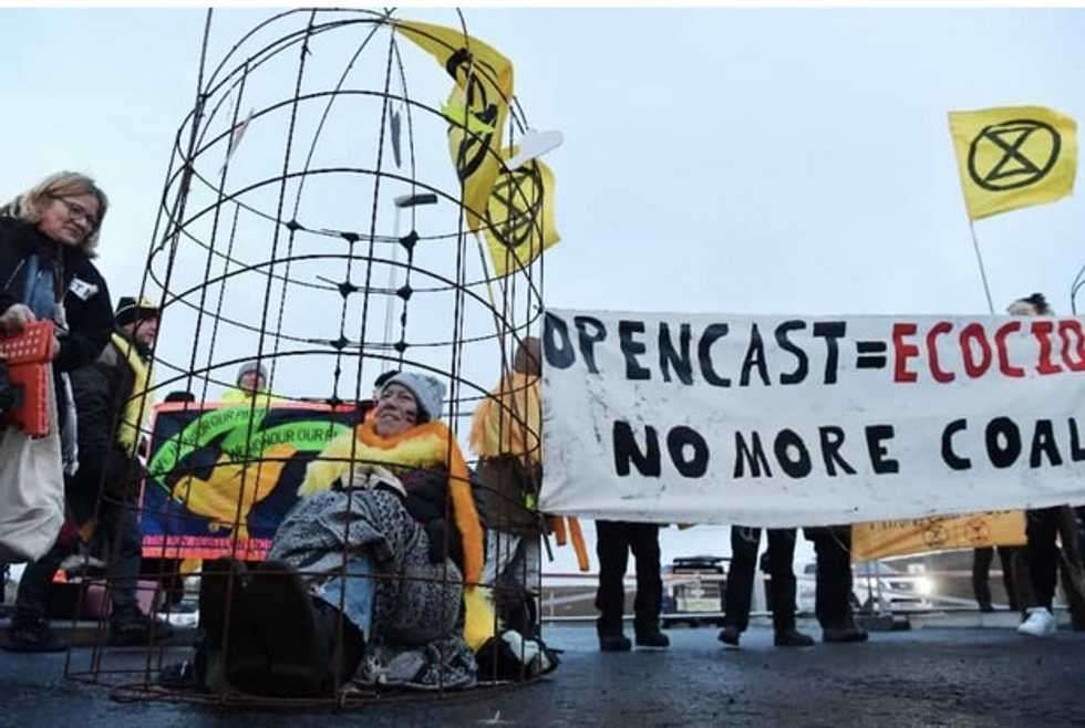 Environmentalists dressed as canaries protest UK coal mine