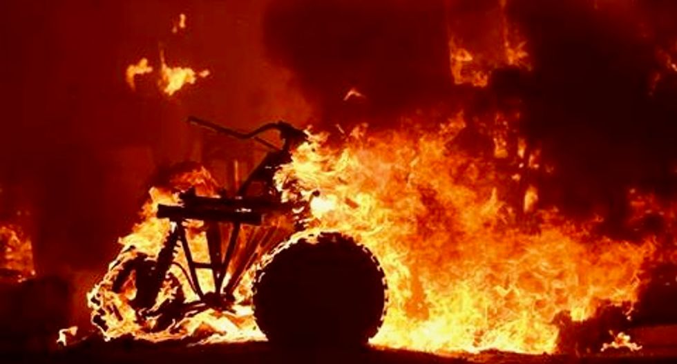 Firefighters battle a dozen wildfires in California as thousands flee their homes