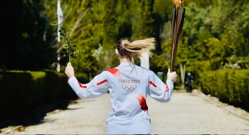 Japan welcomes Olympic flame as doubts swirl over Games