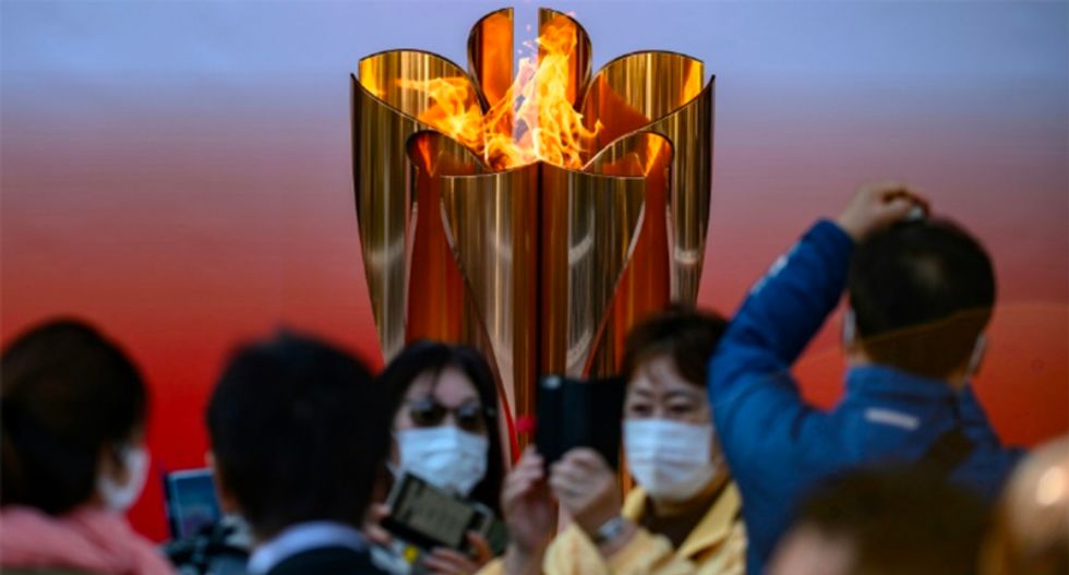Thousands flock to see Olympic flame in Japan despite virus fears