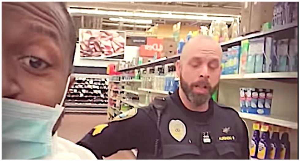 Video shows cop trailing two black men after asking them to leave Walmart for wearing surgical masks