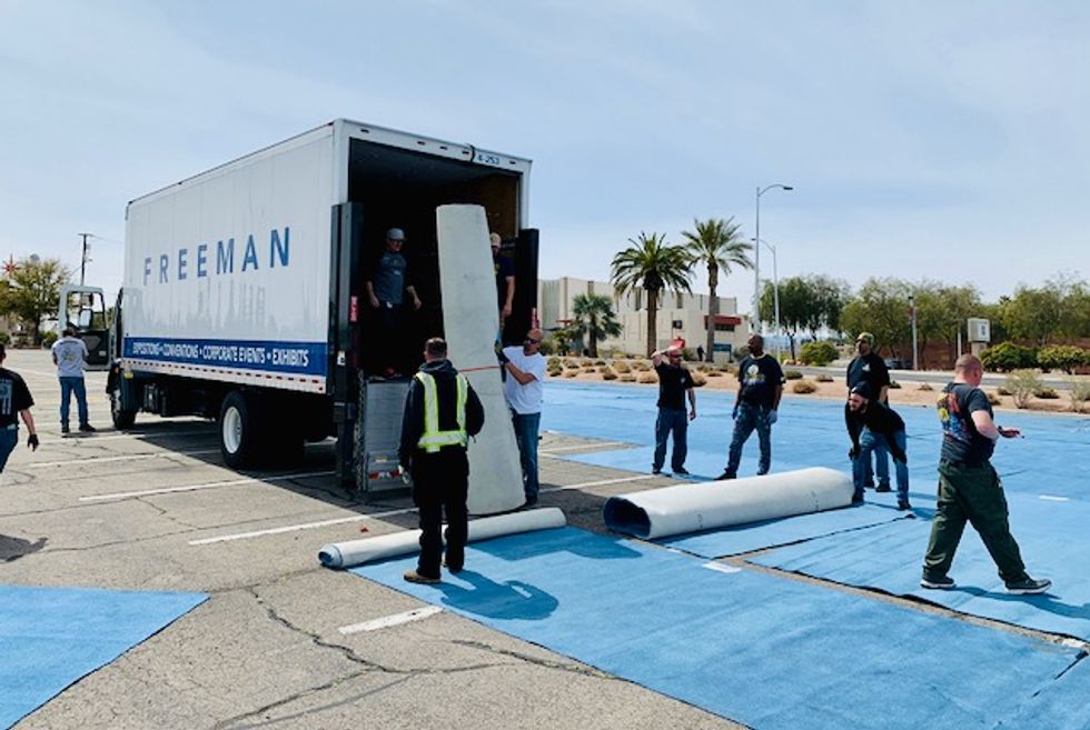 As thousands of Las Vegas hotel rooms sit empty, city paints 'social distancing boxes' in parking lot for homeless people