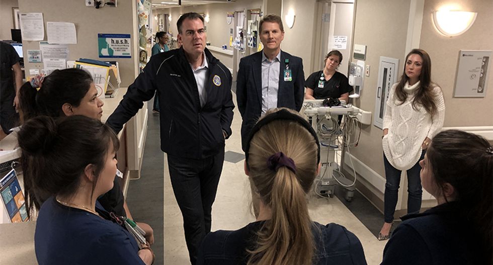 Oklahoma governor criticized for doing coronavirus photo-op outside quarantine without protective equipment