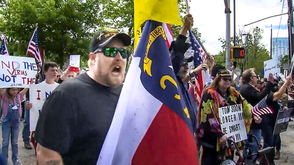 Raleigh police sit silently as white protester calls them Nazis: 'Following orders is not an excuse'