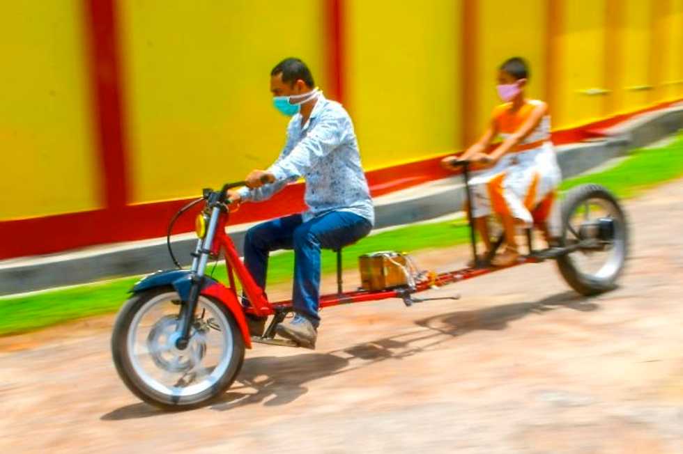 Indian mechanic invents 'social distancing' motorbike