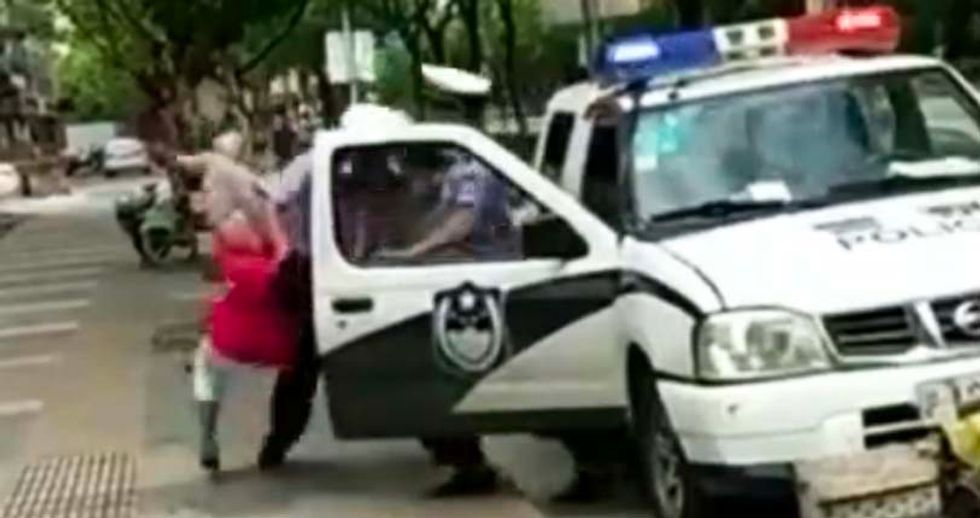 WATCH: Cop slams woman with child in her arms to the sidewalk -- over a parking ticket