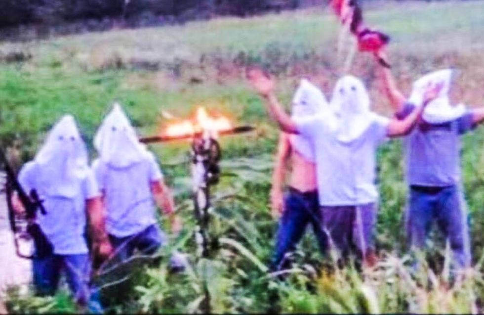 Iowa high school tight-lipped after armed students caught burning a cross in KKK hoods