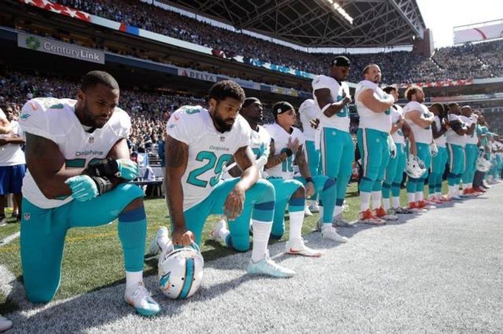 Group of Miami Dolphins players kneel in protest during national anthem
