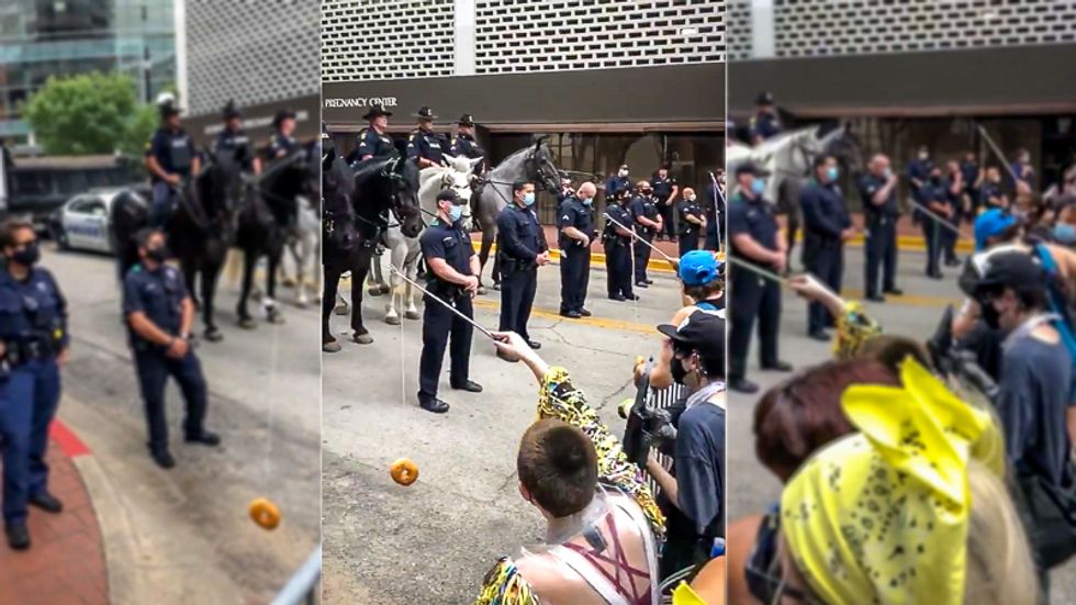 Protesters outside Mike Pence's megachurch speech 'tempt' police with donuts on sticks