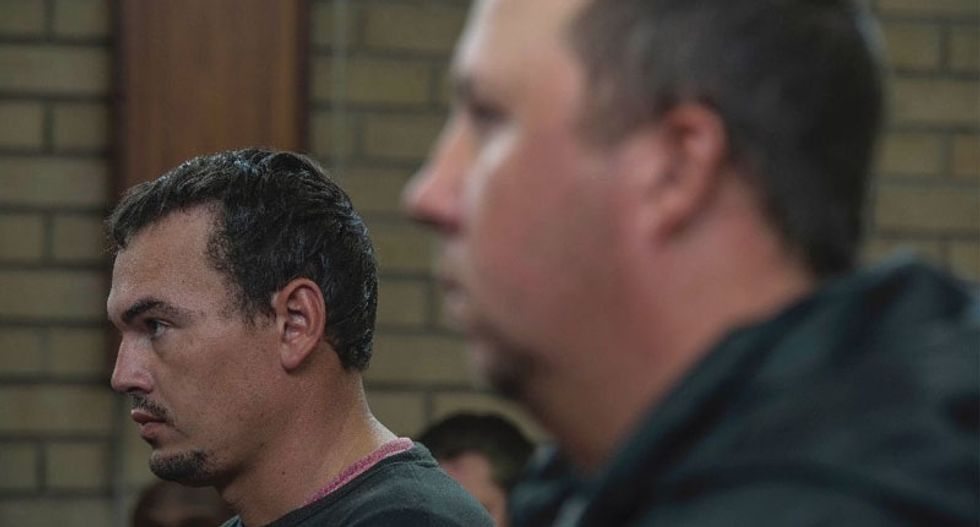 South African farmers in court for shoving black man into coffin