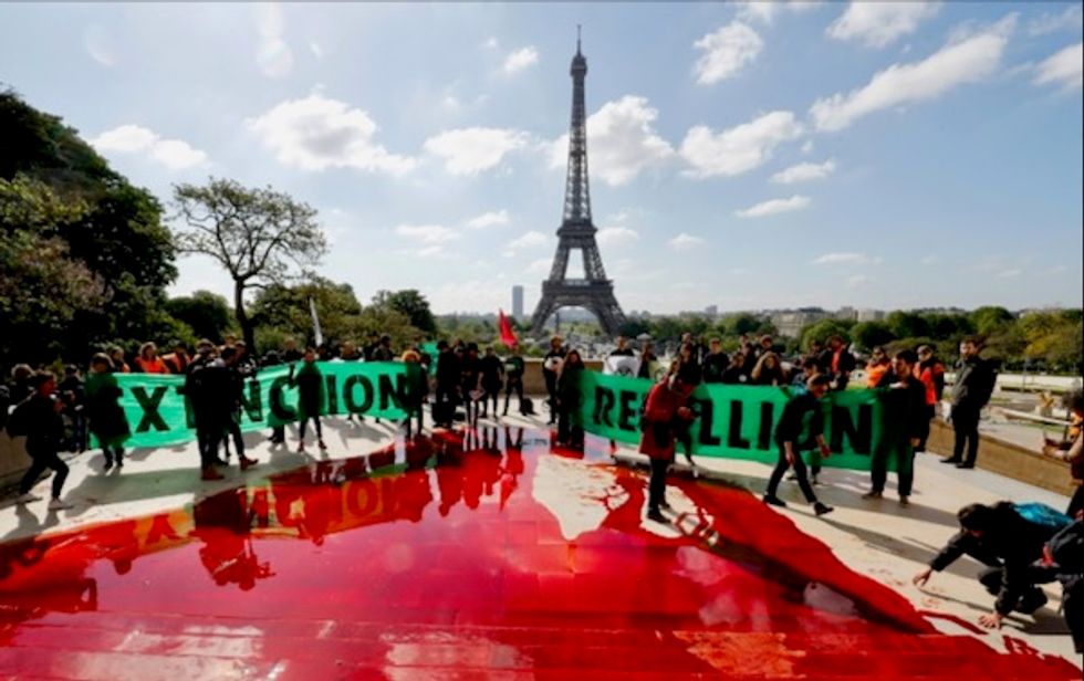 Fake blood flows at anti-extinction protest in Paris