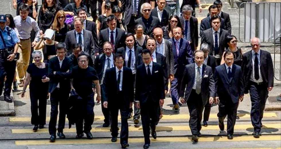 Hong Kong lawyers march in silence to support democracy protesters