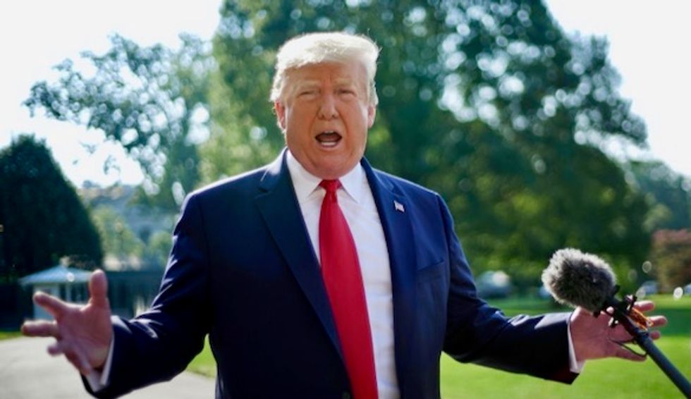 Trump denies stoking extremism on visit to massacre sites