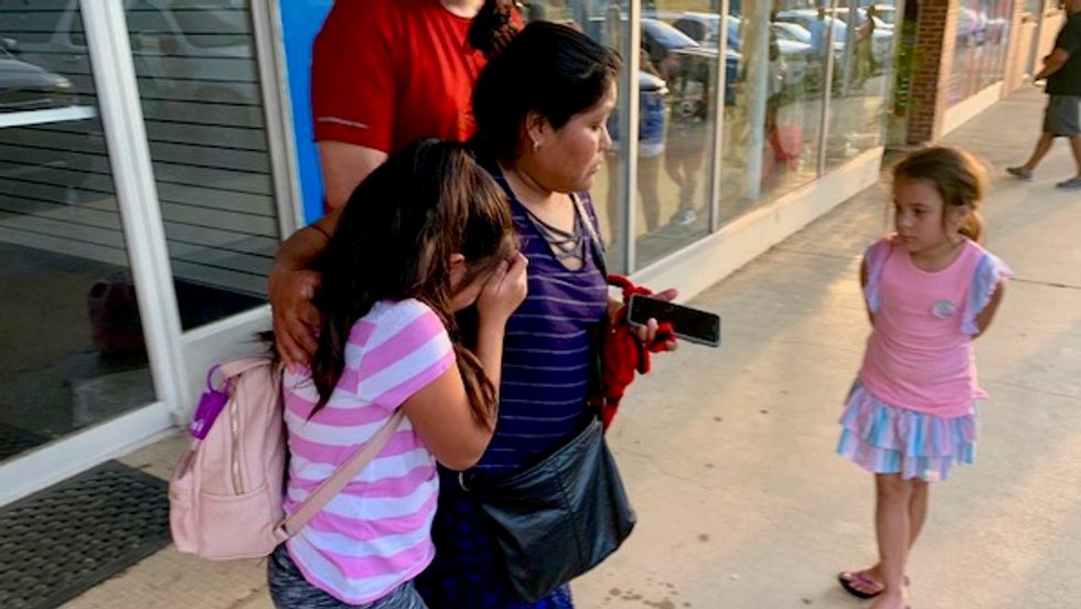 'Don't look away': Videos and images of weeping children and loved ones spread as ICE arrests 680 in Mississippi