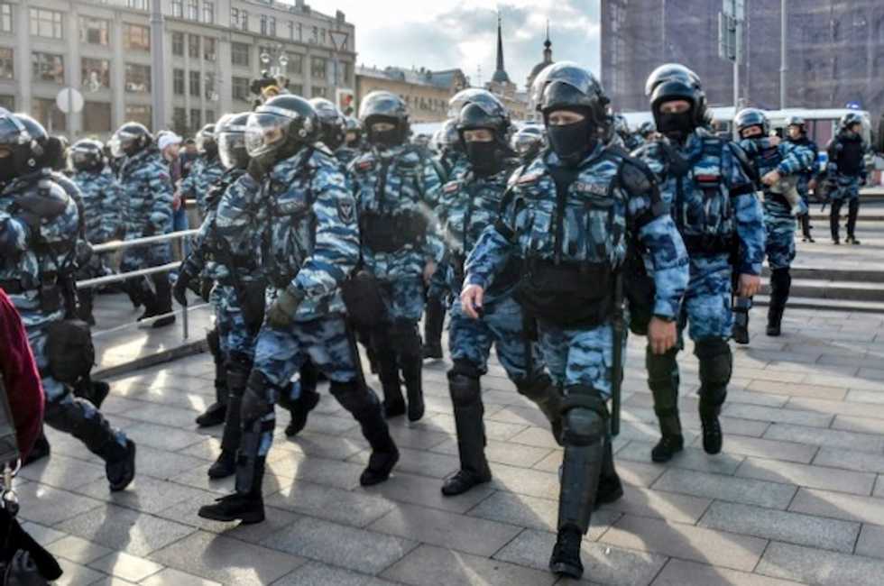 Russian police probe video of officer beating woman