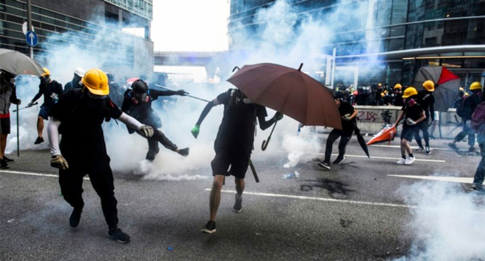 Hong Kong police threaten use of water cannon in latest clashes