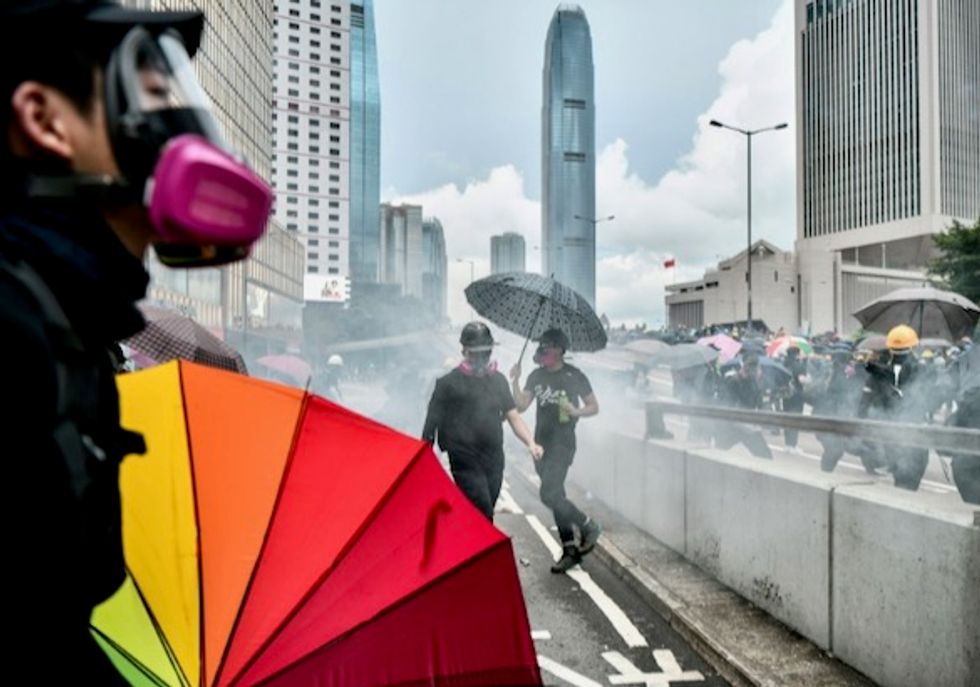 Police fire water cannon, tear gas to clear HK protesters from parliament area