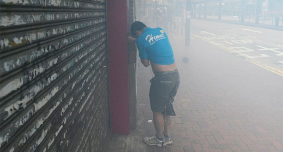Hong Kong police fire tear gas at protesters in shopping district